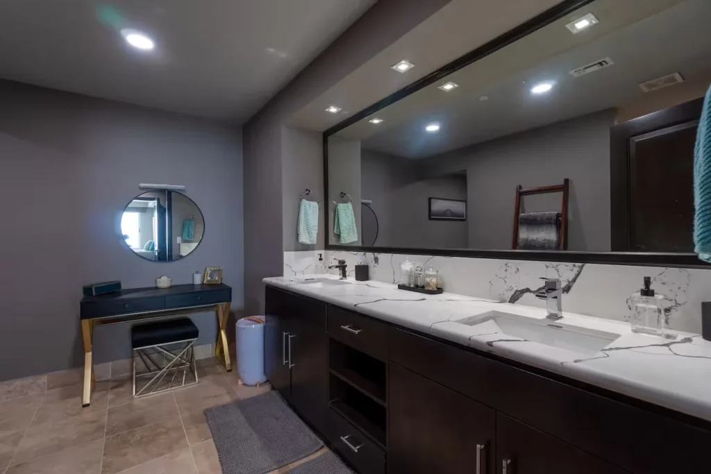 bathroom with a double vanety and a large mirror