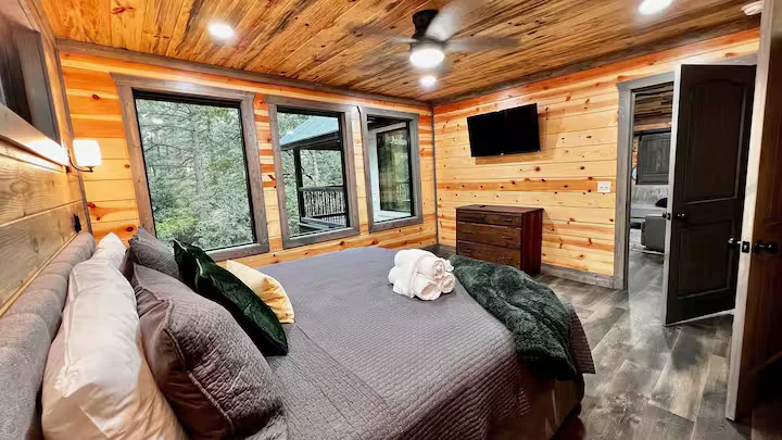bedroom with attached tv on wall