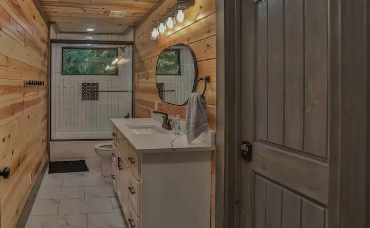 Sasquatch Sanctuary (Broken Bow, OK) - bathroom with vanity and a bathtub